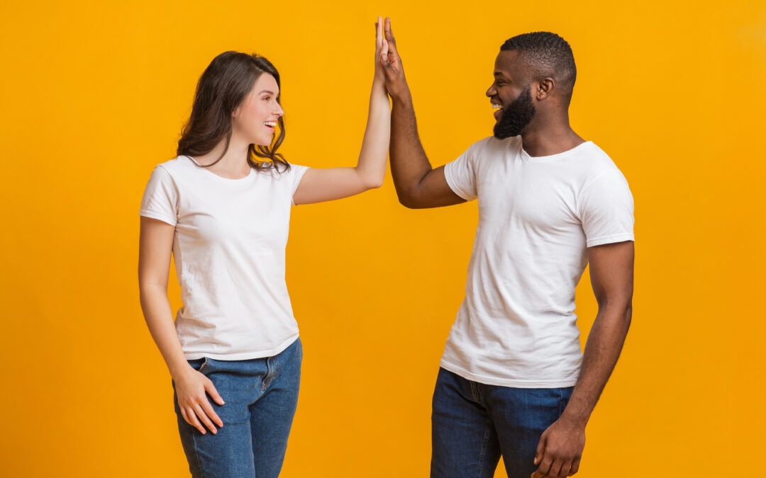 Joyful Interracial Couple Giving High Five To Each Other