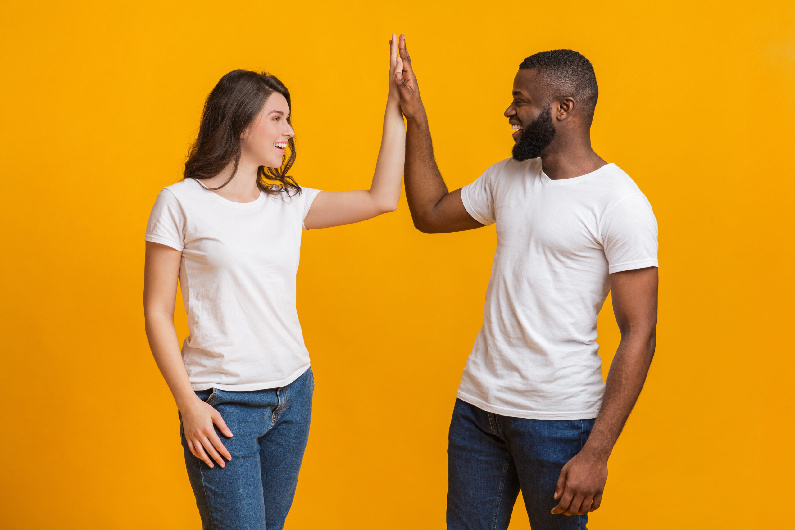 Joyful Interracial Couple Giving High Five To Each Other